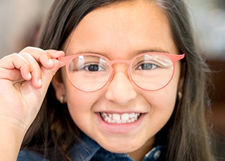 Little girl with glasses smiling