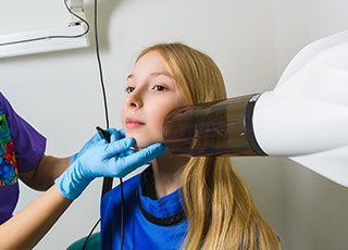 Young girl receiving dental x-rays